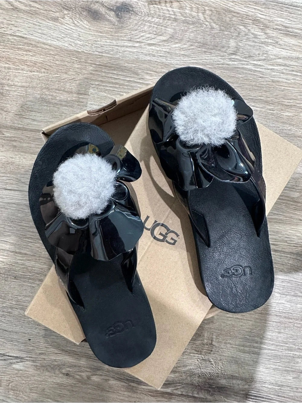 Used Little Girls UGG Black Patent Flip Flops with Light Gray Shearling Pom Pom
